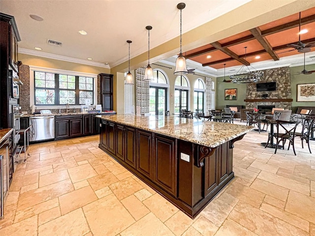 kitchen featuring beam ceiling, coffered ceiling, dark brown cabinetry, a kitchen island, and stainless steel dishwasher