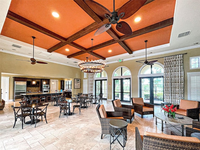 interior space with ornamental molding, coffered ceiling, beam ceiling, and french doors