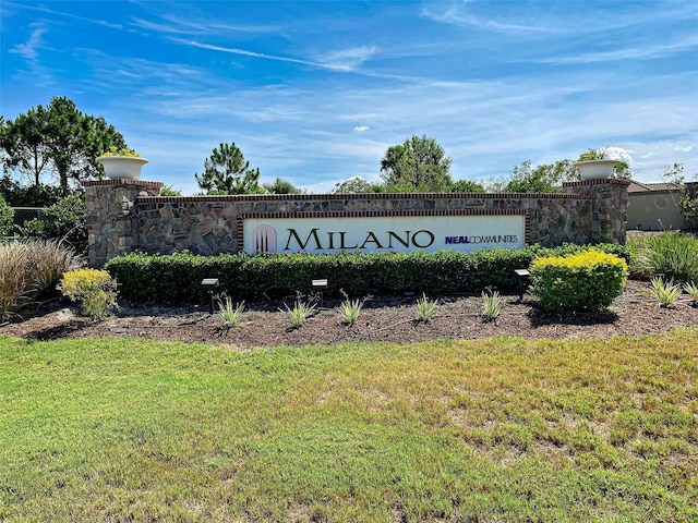 community sign featuring a lawn