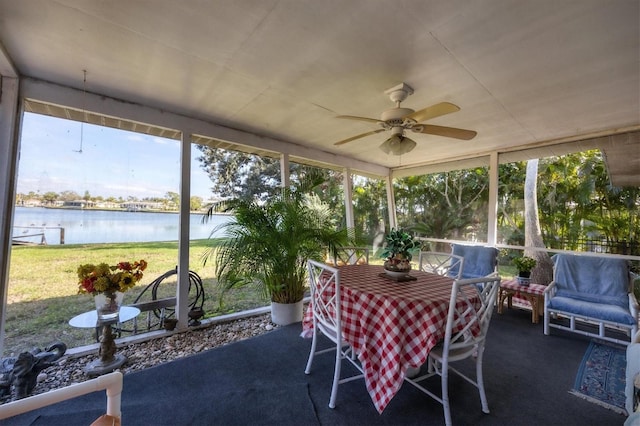 sunroom / solarium with a wealth of natural light, a water view, and ceiling fan