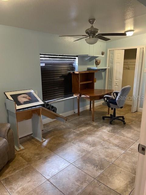 bedroom featuring ceiling fan and a closet