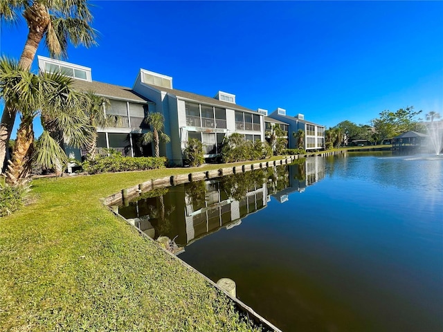 dock area with a yard and a water view