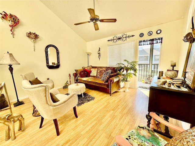 living room featuring wood-type flooring, ceiling fan, and lofted ceiling