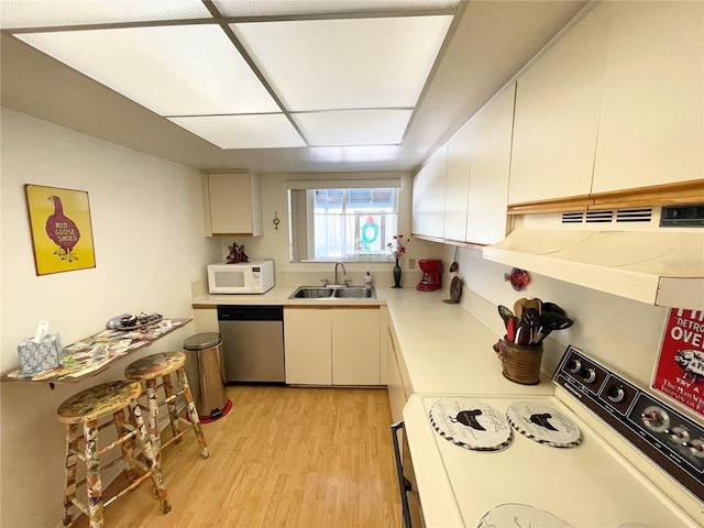 kitchen featuring white appliances, light hardwood / wood-style flooring, white cabinetry, and sink