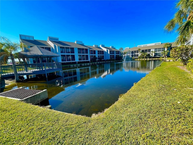 dock area with a water view and a yard