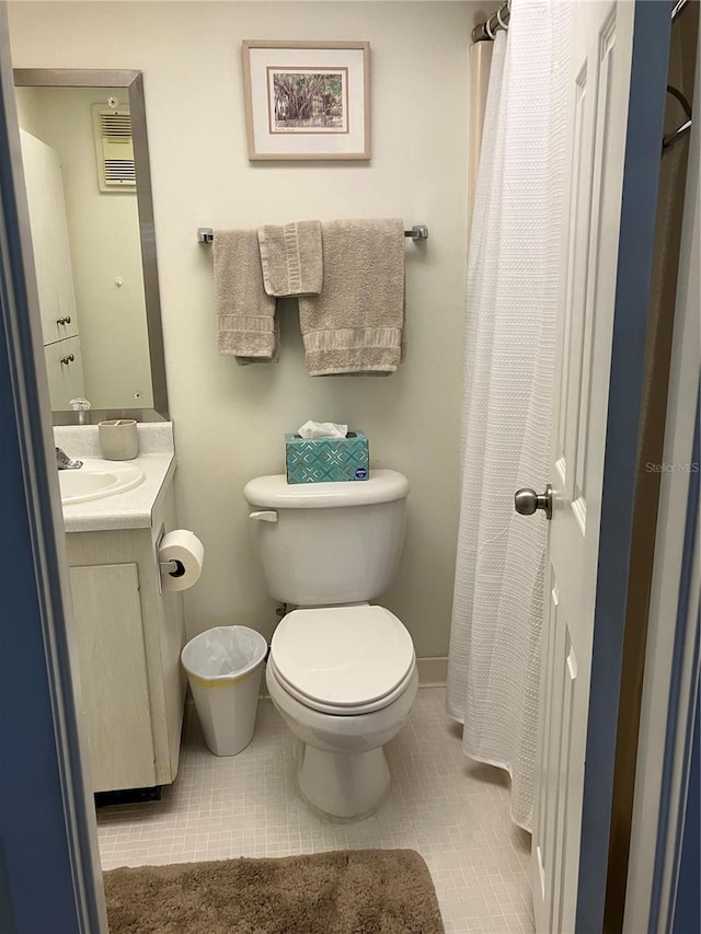 bathroom featuring toilet, vanity, and tile patterned floors