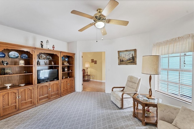 carpeted living room featuring ceiling fan