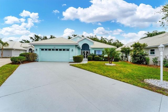 view of front of house with a garage and a front yard