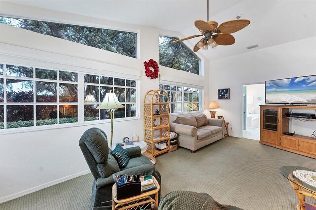 living room with ceiling fan, carpet flooring, and high vaulted ceiling