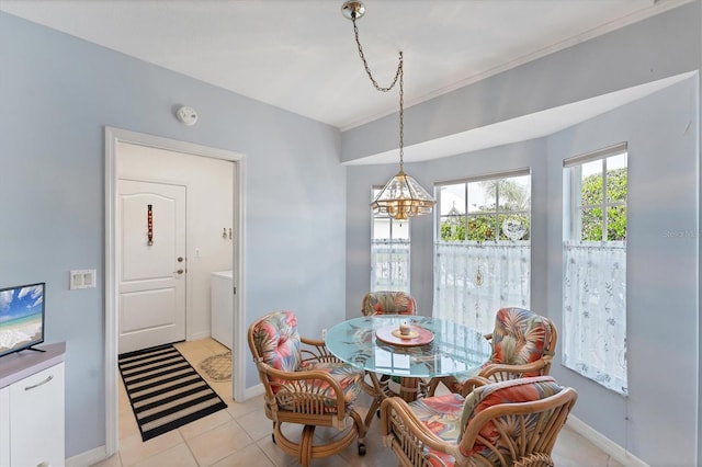 dining space featuring a notable chandelier and light tile patterned floors