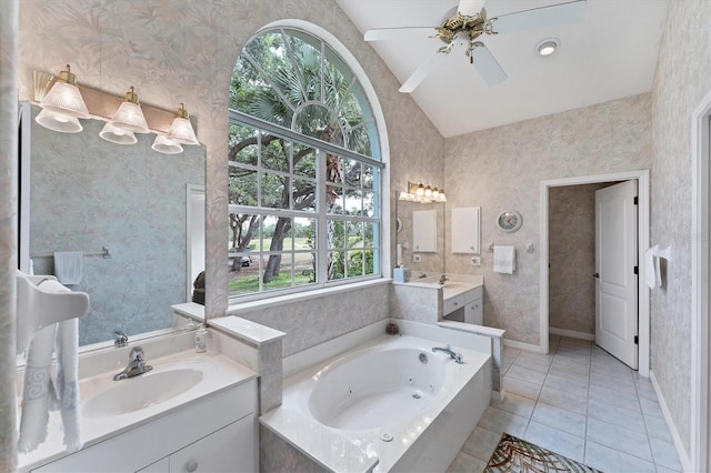 bathroom featuring lofted ceiling, ceiling fan, vanity, tile patterned floors, and a tub