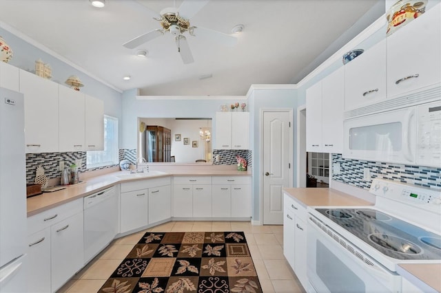 kitchen with white cabinetry, light tile patterned floors, white appliances, and vaulted ceiling