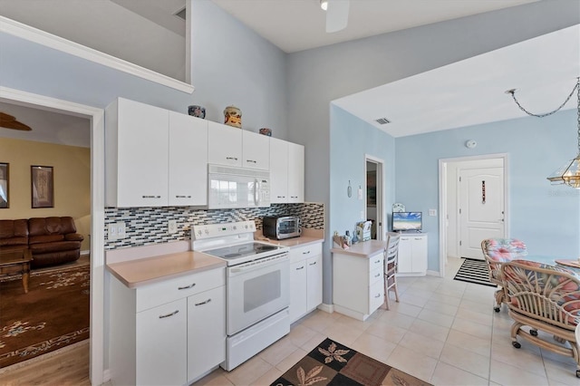 kitchen featuring ceiling fan, white appliances, backsplash, and white cabinets