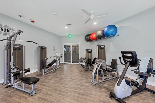 gym featuring ceiling fan and wood-type flooring