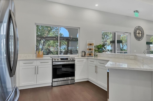 kitchen with dark hardwood / wood-style floors, white cabinets, kitchen peninsula, stainless steel appliances, and light stone countertops