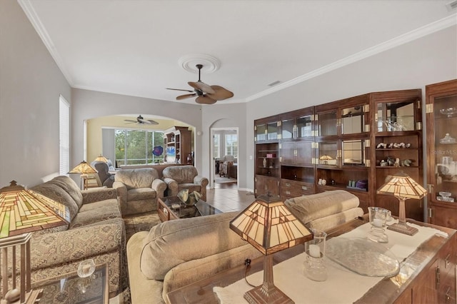 living room featuring tile patterned flooring, ceiling fan, and ornamental molding