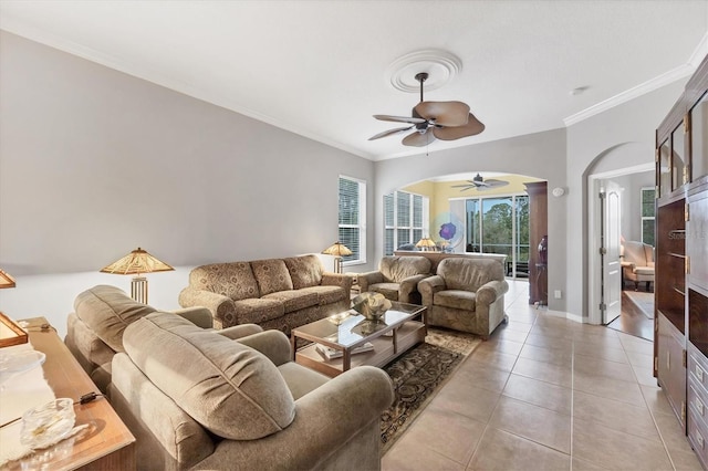 living room with crown molding, light tile patterned flooring, and ceiling fan