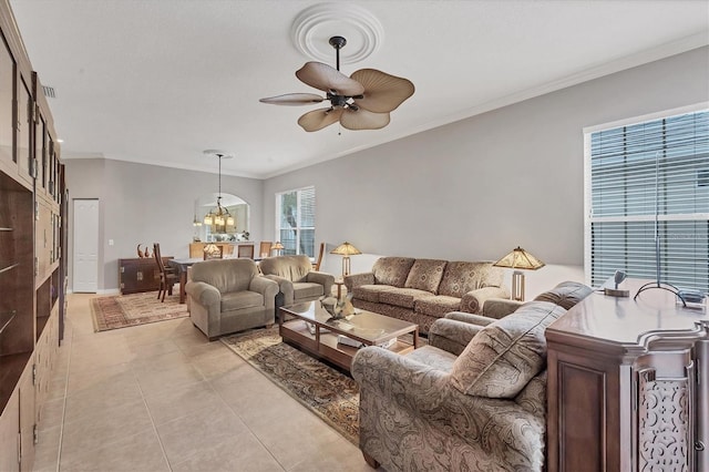 tiled living room featuring ceiling fan with notable chandelier and crown molding