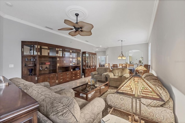 living room with ceiling fan, light tile patterned floors, and ornamental molding