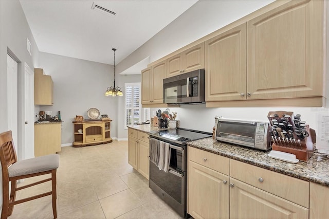 kitchen with electric range, light brown cabinets, and decorative light fixtures