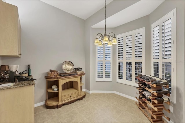 wine room with light tile patterned floors and an inviting chandelier