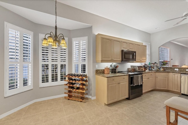 kitchen with decorative light fixtures, light brown cabinets, a healthy amount of sunlight, and appliances with stainless steel finishes