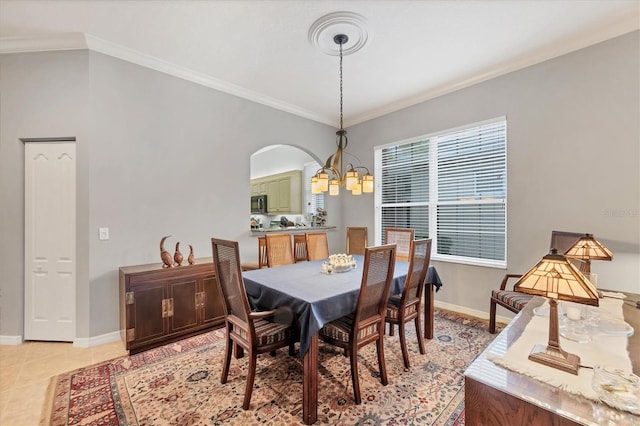 dining room featuring an inviting chandelier, light tile patterned floors, and ornamental molding