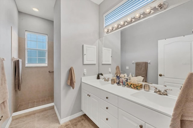 bathroom featuring a shower, vanity, and tile patterned floors