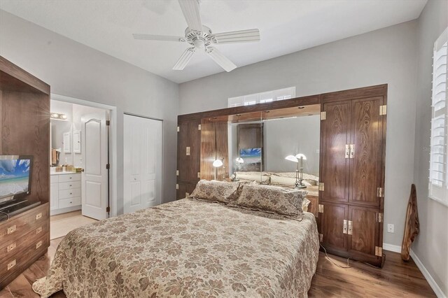 bedroom featuring ceiling fan, light wood-type flooring, ensuite bathroom, and a closet