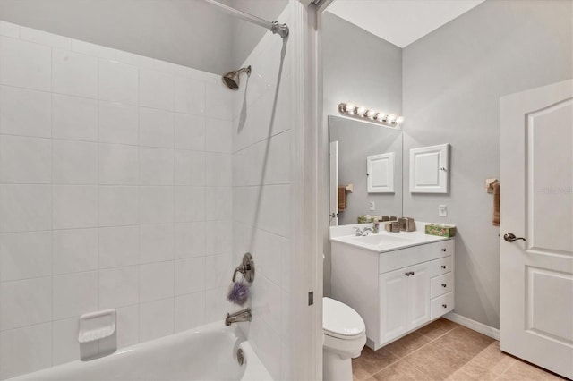 full bathroom featuring tile patterned floors, vanity, tiled shower / bath combo, and toilet