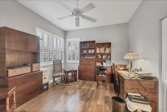 office with light wood-type flooring and ceiling fan