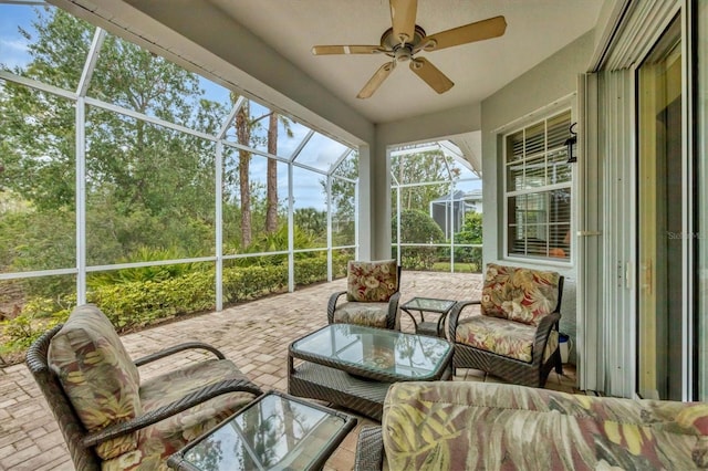 sunroom / solarium featuring ceiling fan