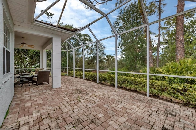 unfurnished sunroom with ceiling fan