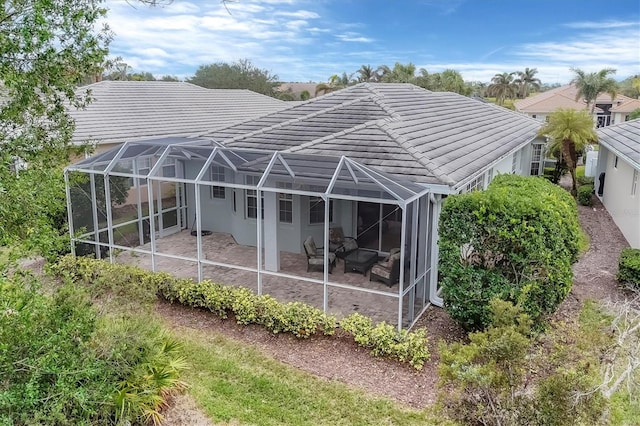 rear view of house featuring a patio area and a lanai