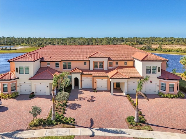 mediterranean / spanish house featuring a water view