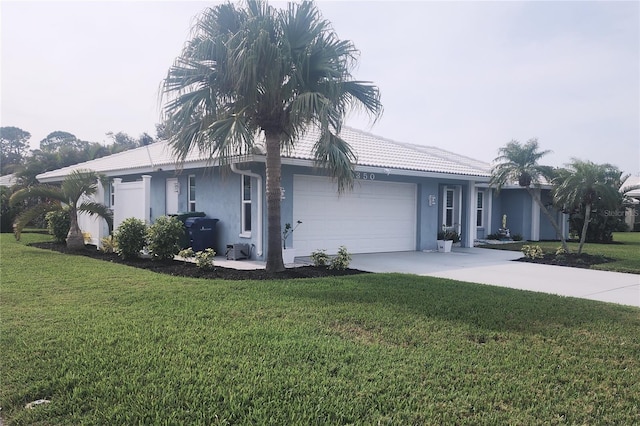 single story home with a front yard and a garage