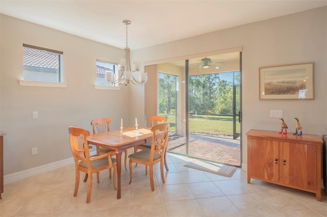 dining space with light tile patterned flooring and ceiling fan with notable chandelier