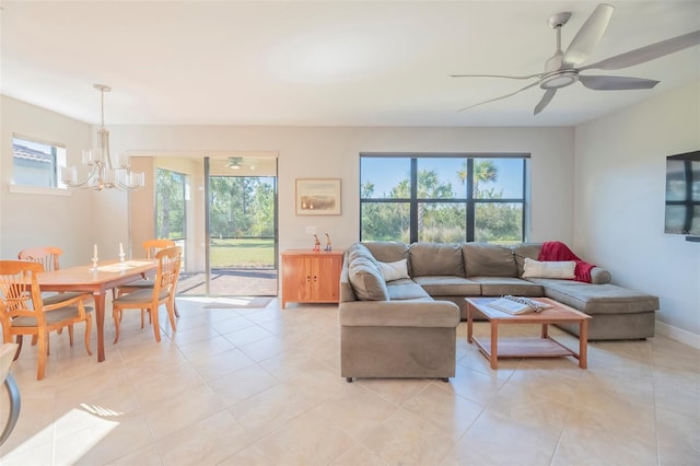 living room featuring light tile patterned floors and ceiling fan with notable chandelier