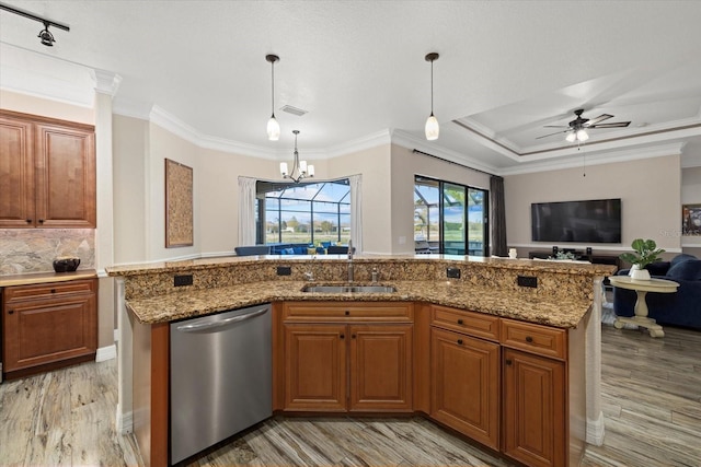 kitchen featuring a center island with sink, light wood-type flooring, dishwasher, hanging light fixtures, and sink