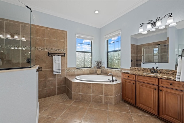 bathroom with plus walk in shower, ornamental molding, tile patterned floors, and vanity