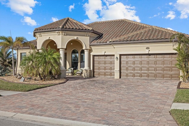 mediterranean / spanish-style home featuring a garage