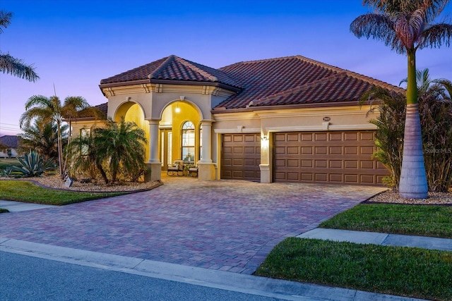 mediterranean / spanish house featuring a garage