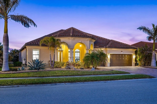 mediterranean / spanish-style home featuring a garage