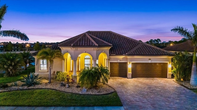 mediterranean / spanish-style home with a garage