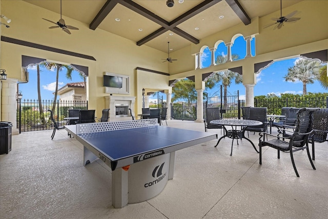 view of patio featuring ceiling fan and exterior fireplace