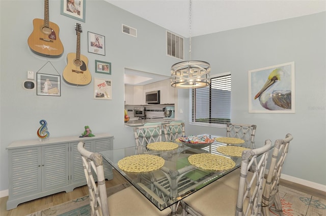 dining room featuring an inviting chandelier and light hardwood / wood-style floors