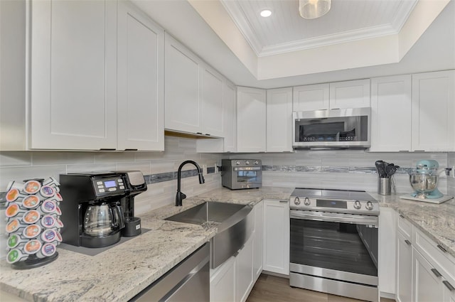 kitchen with white cabinets and appliances with stainless steel finishes