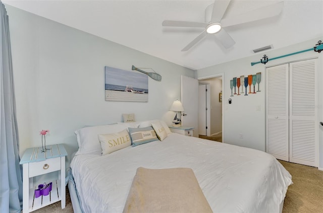 carpeted bedroom featuring ceiling fan and a closet