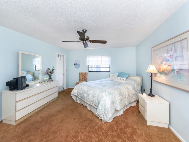 carpeted bedroom featuring a textured ceiling and ceiling fan