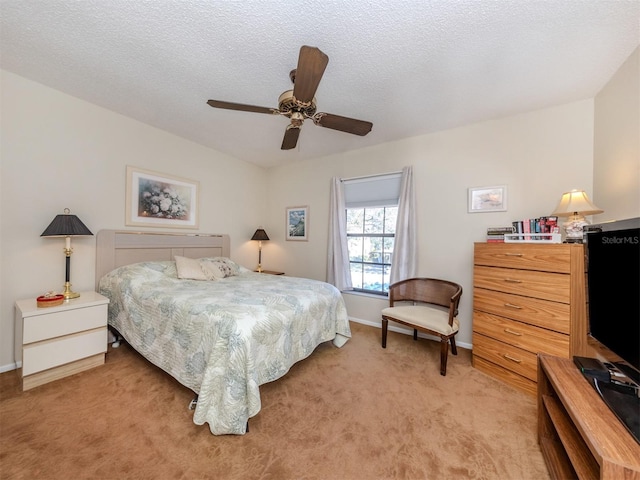 bedroom featuring ceiling fan, a textured ceiling, and light carpet